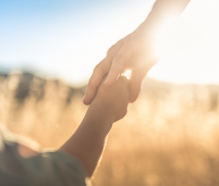 Social responsibility - old and young holding hands